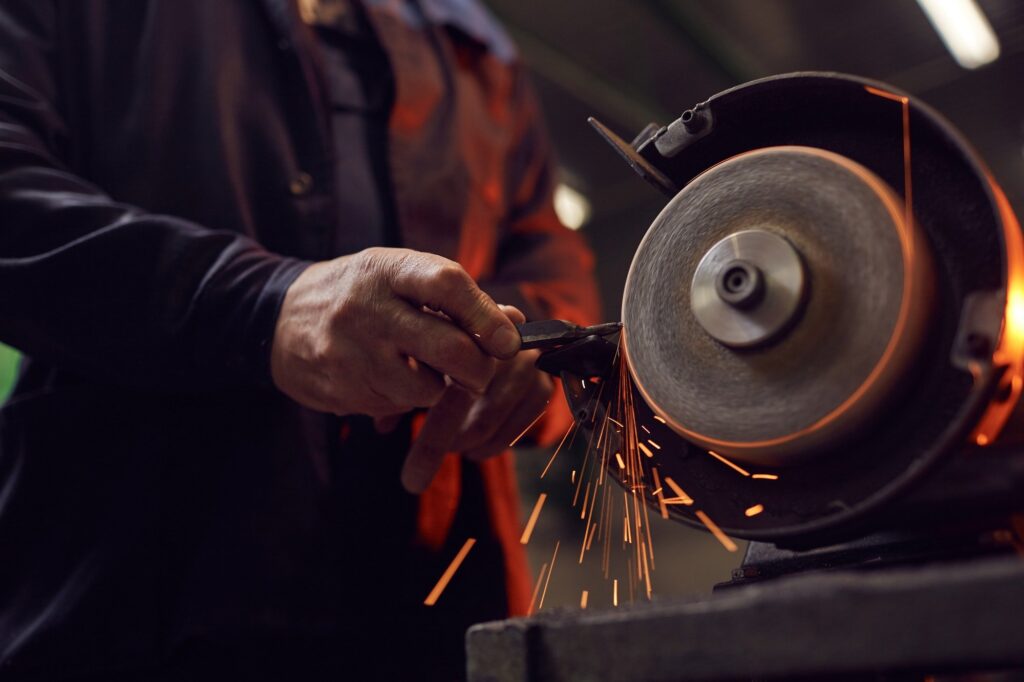 Worker working on grinder